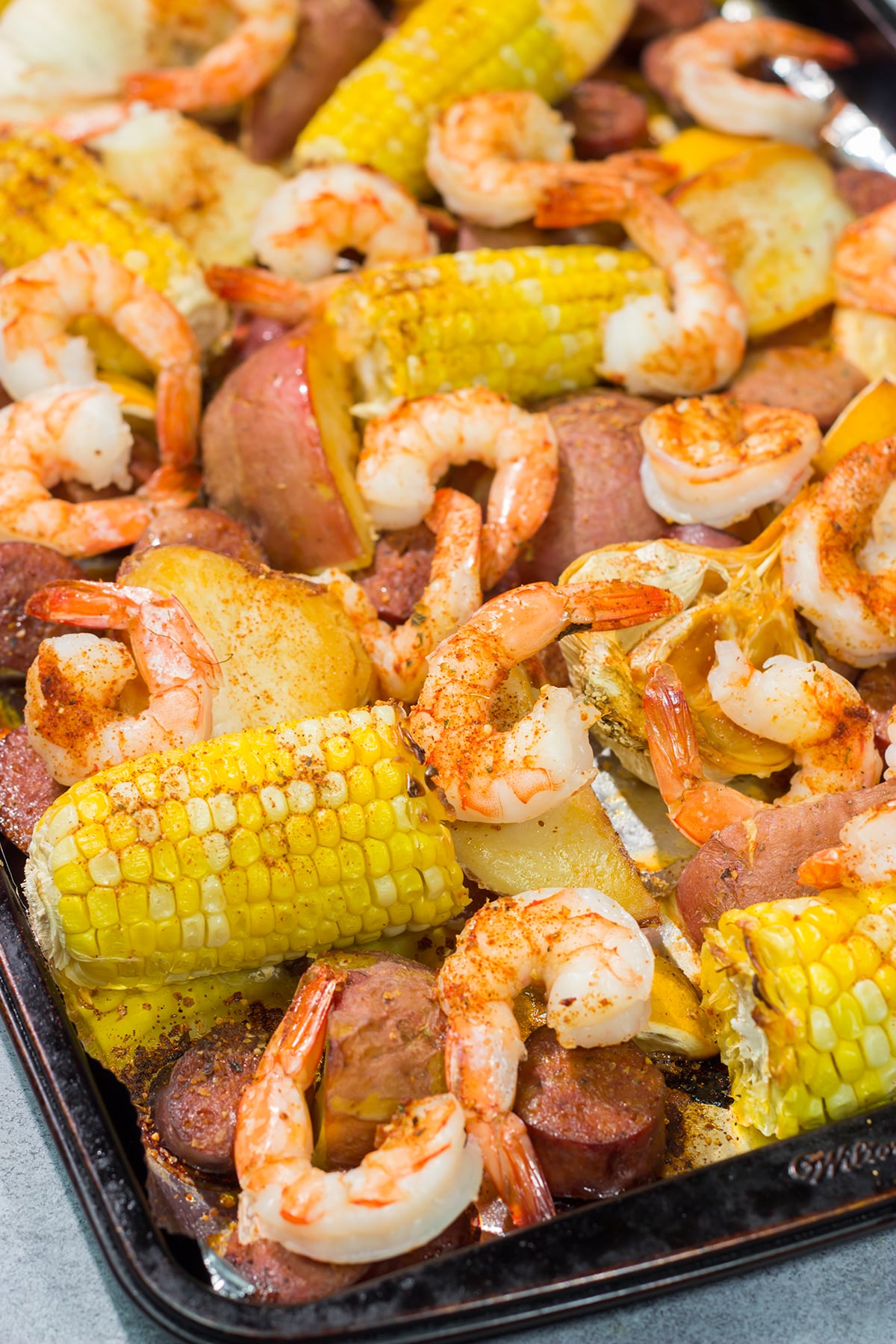 This Sheet Pan Lowcountry Boil recipe features all of the flavors of a traditional shrimp boil...but it gets baked in the oven instead!