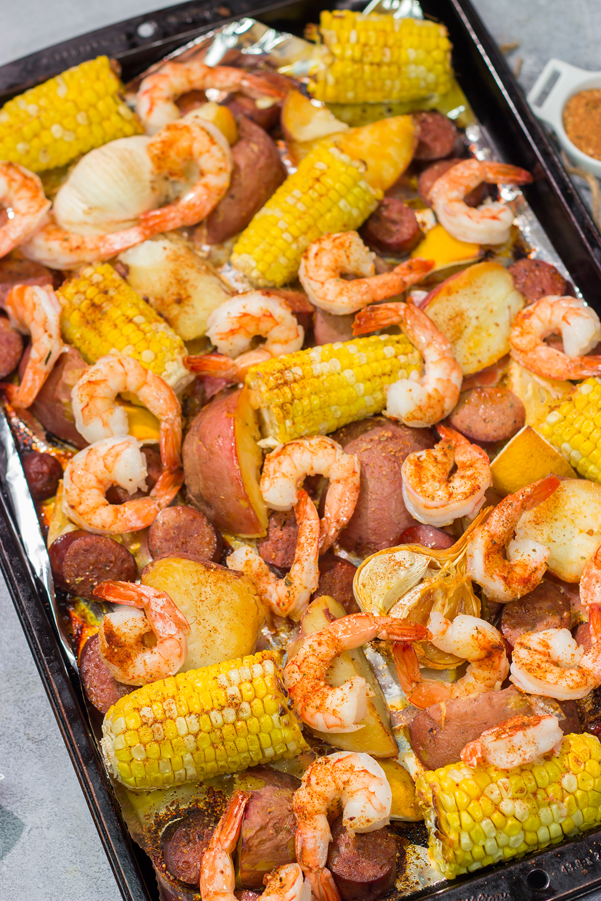 This Sheet Pan Lowcountry Boil recipe features all of the flavors of a traditional shrimp boil...but it gets baked in the oven instead!