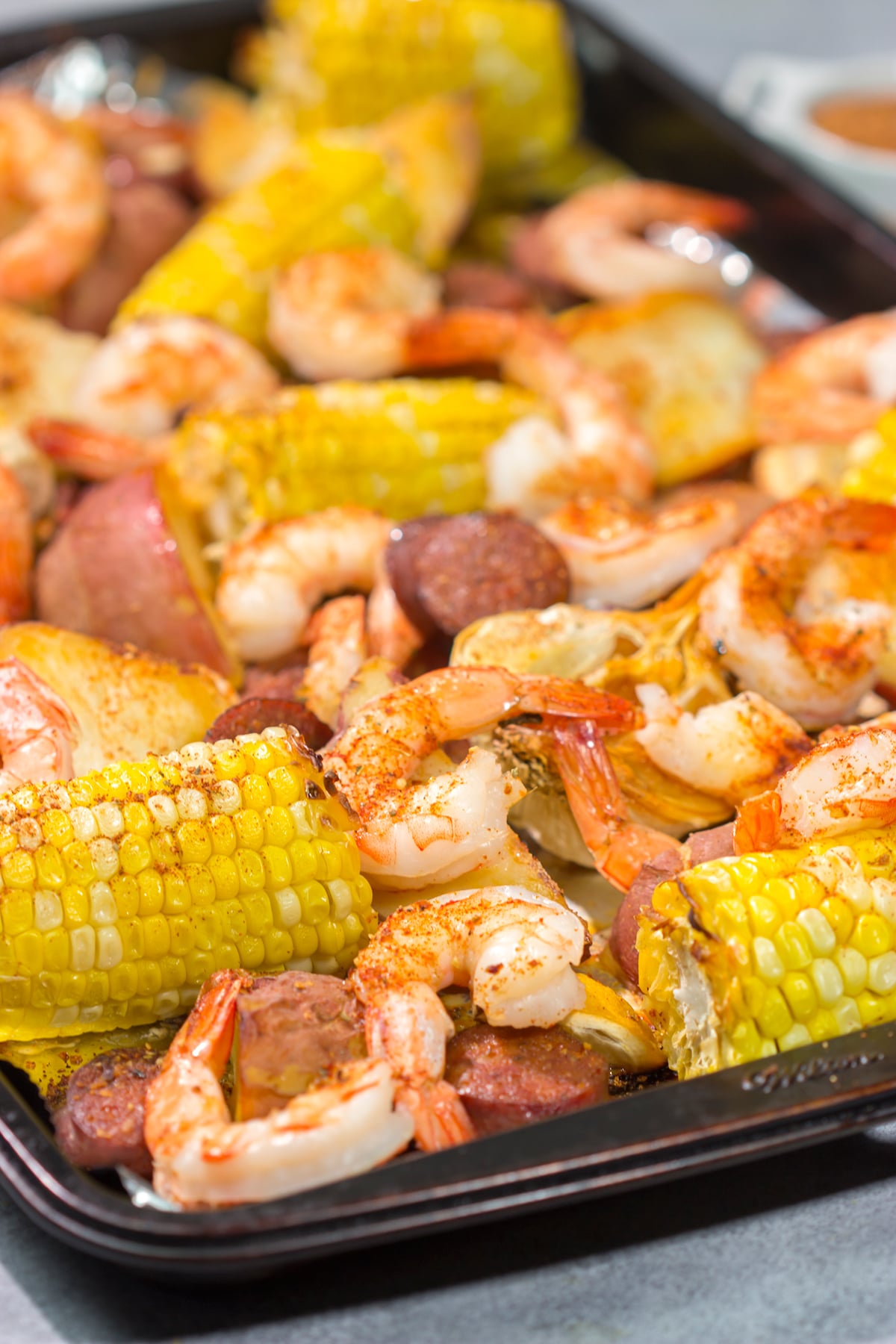 This Sheet Pan Lowcountry Boil recipe features all of the flavors of a traditional shrimp boil...but it gets baked in the oven instead!