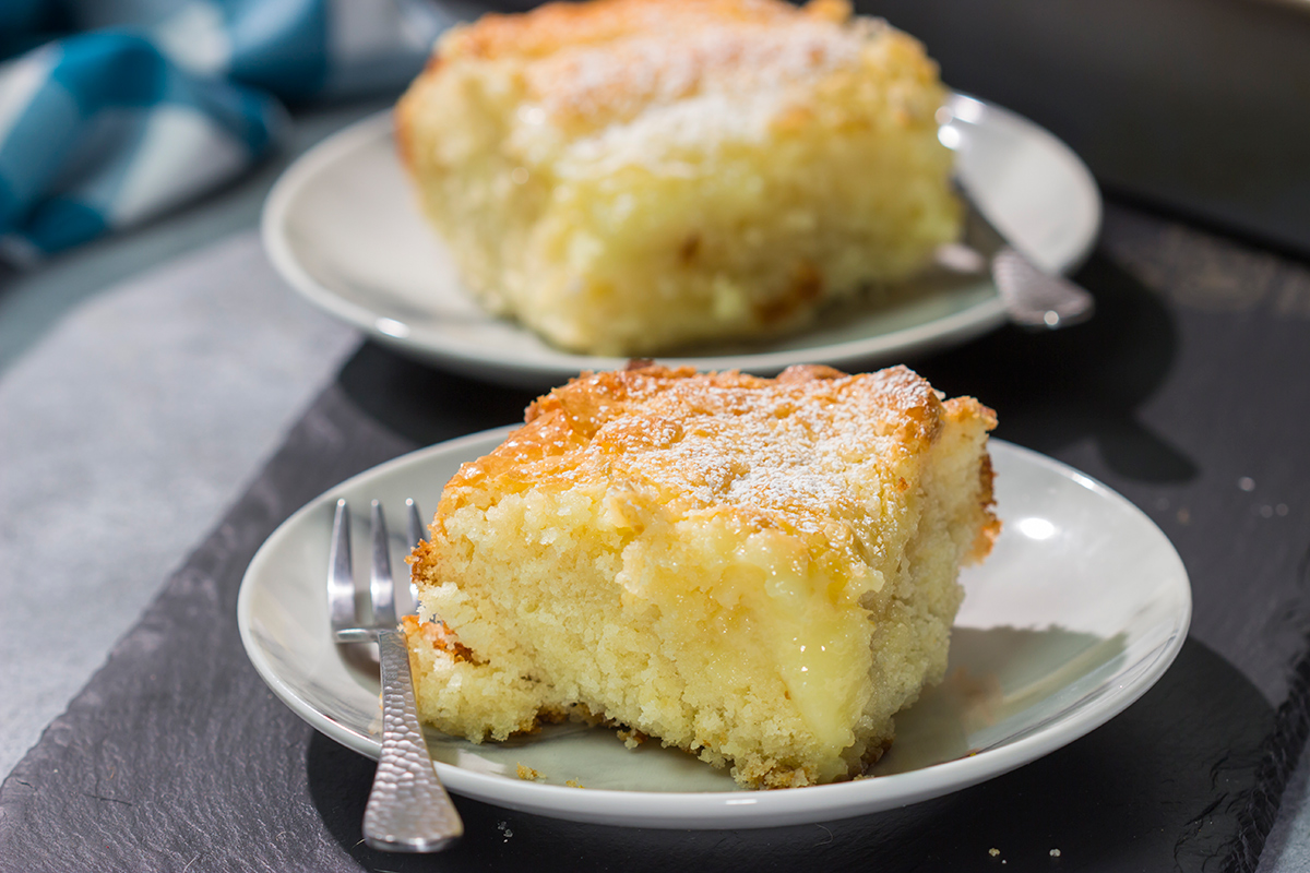 A classic St. Louis dessert, a Gooey Butter Cake features a buttery cake base topped with a vanilla cream cheese layer - it is absolutely addicting! Say hello to your new favorite dessert!