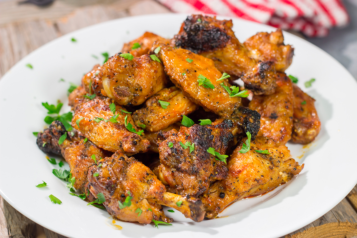 These Grilled Buffalo Wings are juicy and delicious - and tossed in an easy homemade buffalo sauce. Fire up the grill and invite some friends over!