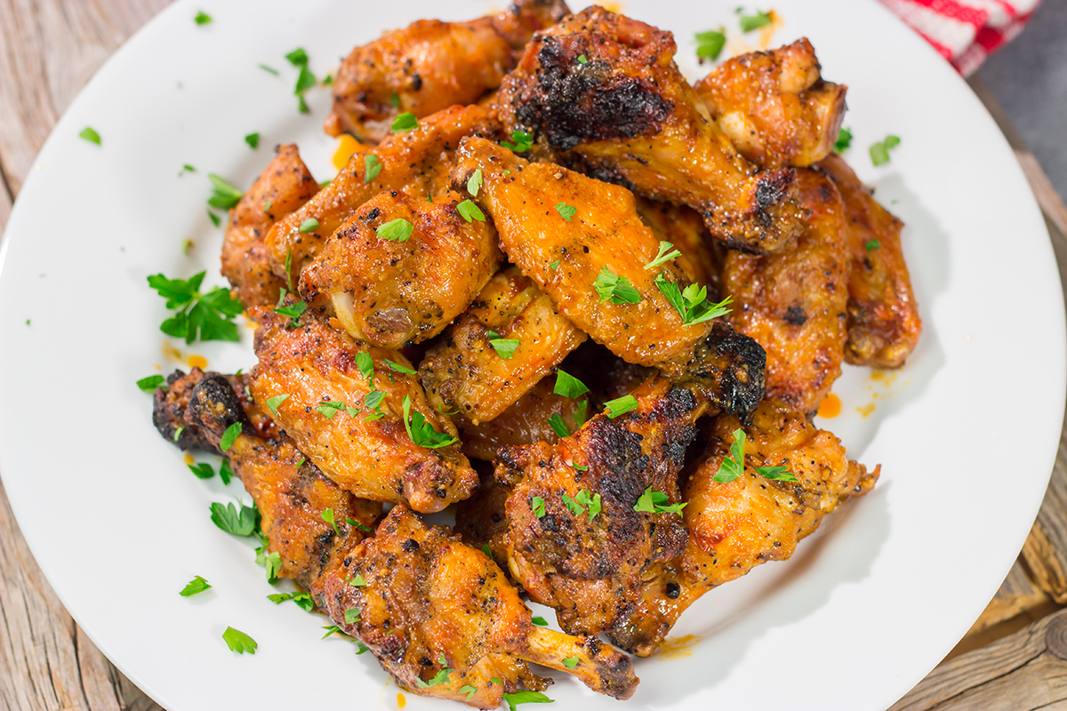 These Grilled Buffalo Wings are juicy and delicious - and tossed in an easy homemade buffalo sauce. Fire up the grill and invite some friends over!