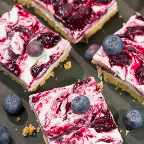 These No Bake Blueberry Cheesecake Bars feature a creamy cheesecake filling swirled with fresh blueberry jam on top of a buttery graham cracker crust. They're perfect for a hot summer day!