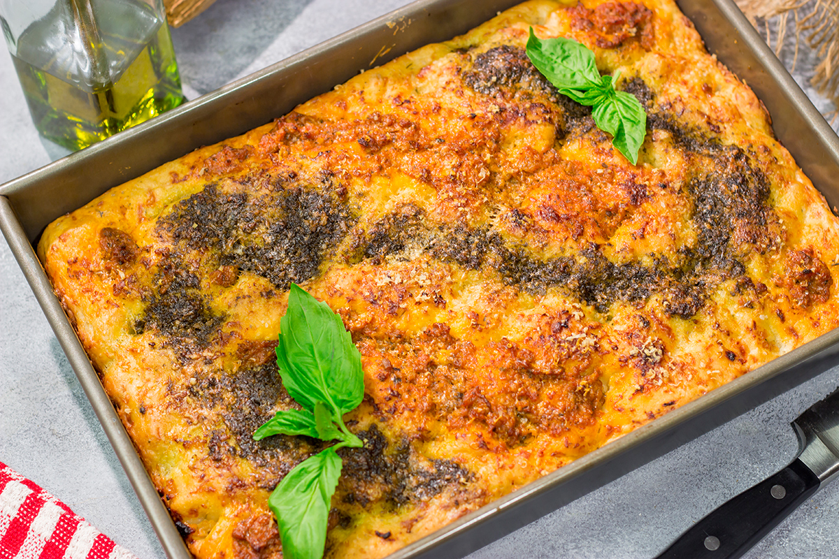 Topped with 2 types of pesto, this Sundried Tomato and Pesto Focaccia is a flavorful and delicious bread. Serve as a side dish or slice in half for a unique sandwich bread!
