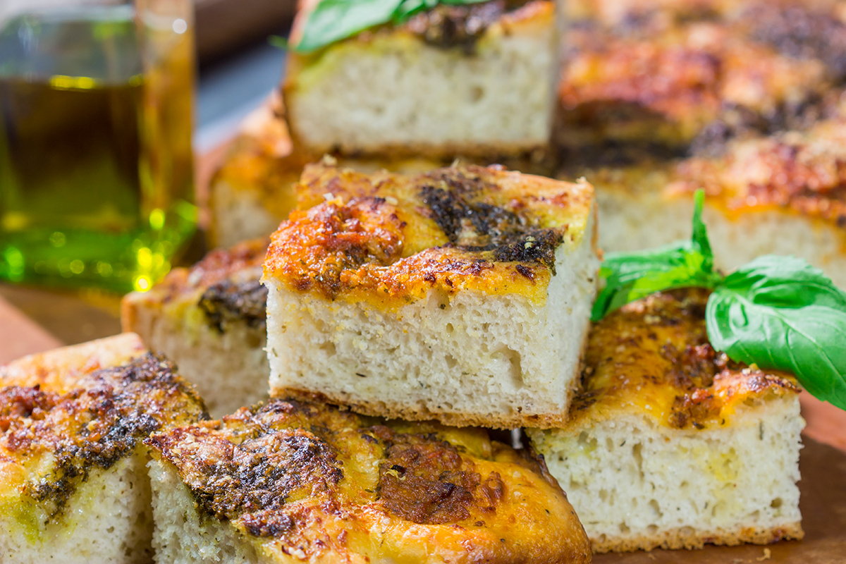 Topped with 2 types of pesto, this Sundried Tomato and Pesto Focaccia is a flavorful and delicious bread. Serve as a side dish or slice in half for a unique sandwich bread!