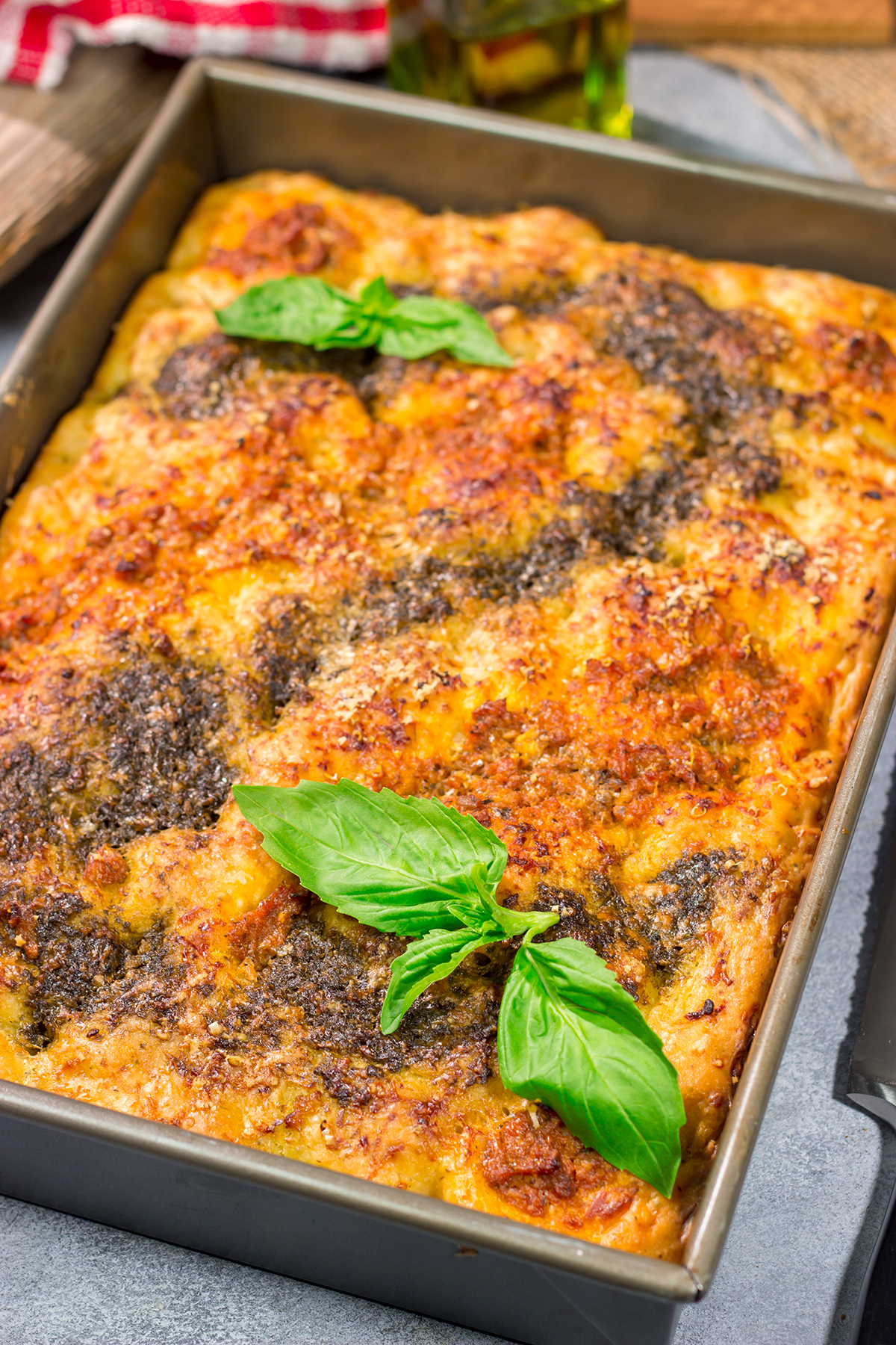 Topped with 2 types of pesto, this Sundried Tomato and Pesto Focaccia is a flavorful and delicious bread. Serve as a side dish or slice in half for a unique sandwich bread!