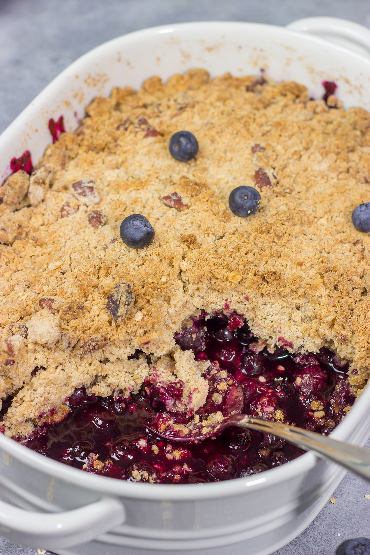This classic Blueberry Crisp recipe features a juicy berry filling topped with a crispy oat streusel. It's the perfect dessert for warm summer evenings!