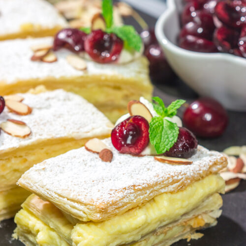 Filled with silky almond pastry cream and topped with juicy cherries, this Cherry Almond Napoleon is a fun twist on the classic French dessert!
