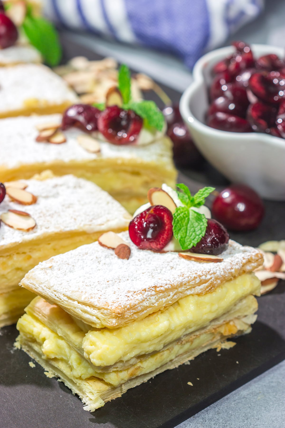 Filled with silky almond pastry cream and topped with juicy cherries, this Cherry Almond Napoleon is a fun twist on the classic French dessert!