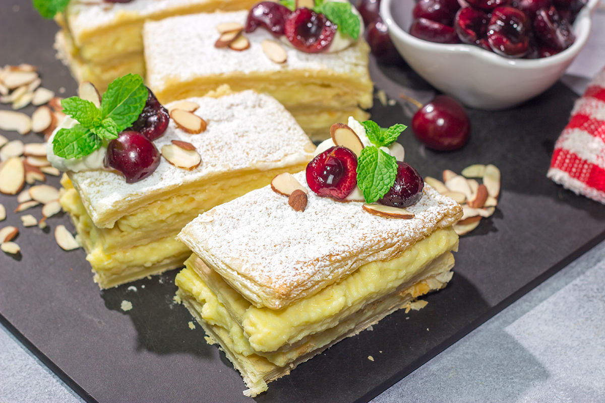 Filled with silky almond pastry cream and topped with juicy cherries, this Cherry Almond Napoleon is a fun twist on the classic French dessert!