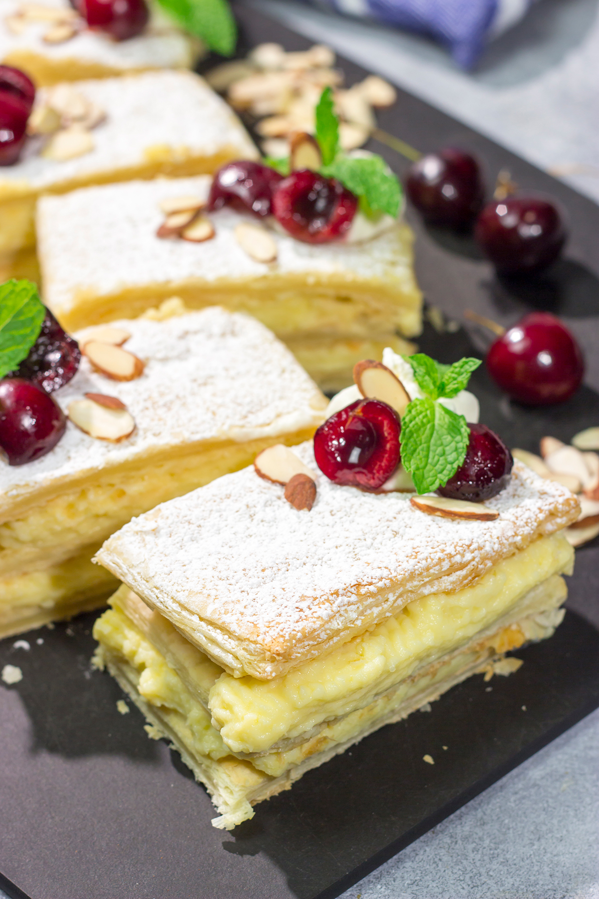 Filled with silky almond pastry cream and topped with juicy cherries, this Cherry Almond Napoleon is a fun twist on the classic French dessert!