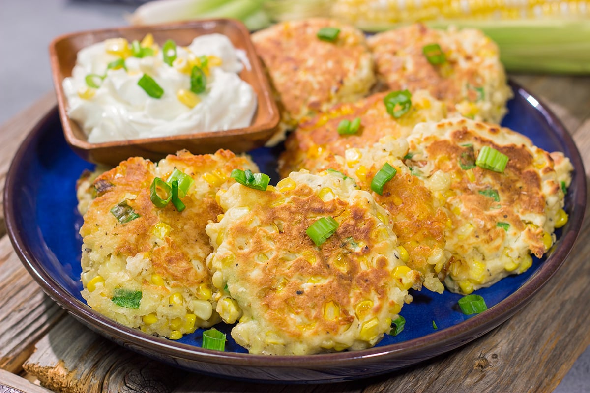 These Corn Fritters feature fresh corn kernels mixed into a simple batter. Serve with a side of sour cream for a delicious summer side dish or appetizer!