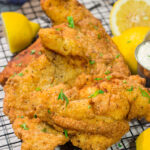 This Fried Catfish features a crispy cornmeal crust over tender catfish filets. Add in a squeeze of lemon and some homemade tartar sauce, and you've got a delicious fish fry recipe!