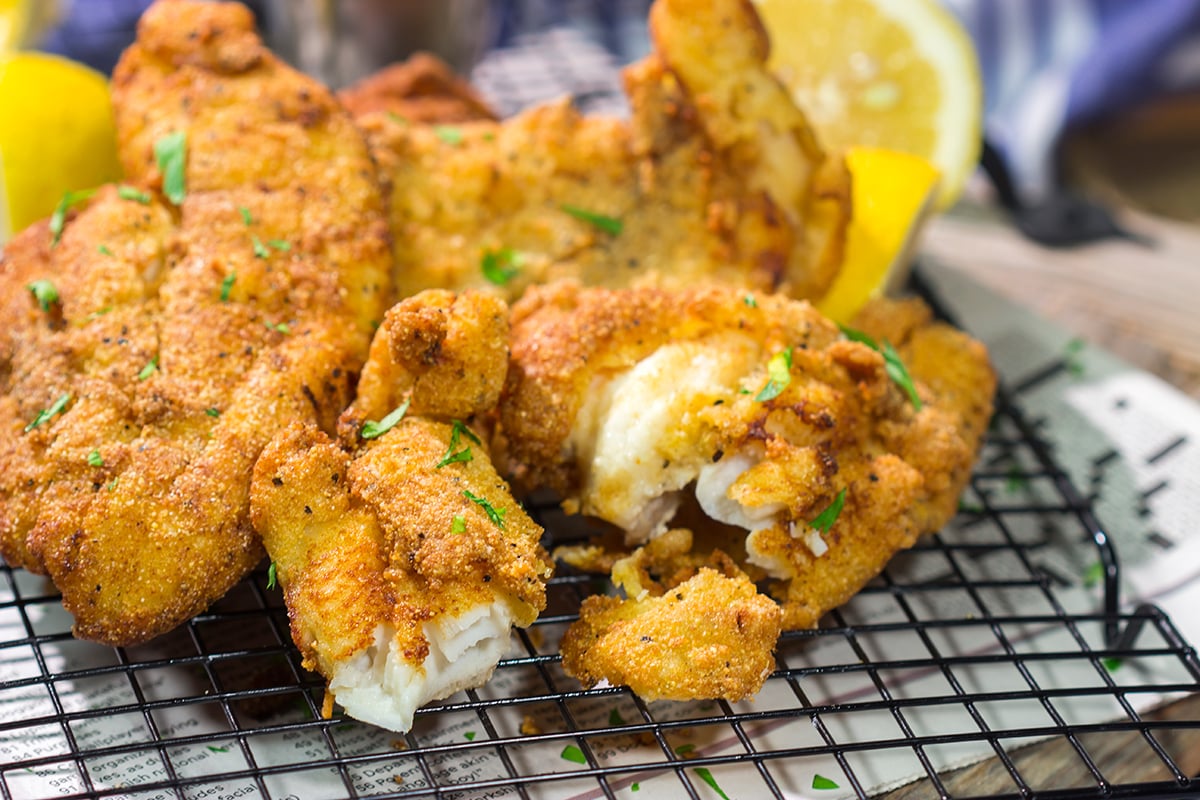 This Fried Catfish features a crispy cornmeal crust over tender catfish filets. Add in a squeeze of lemon and some homemade tartar sauce, and you've got a delicious fish fry recipe!