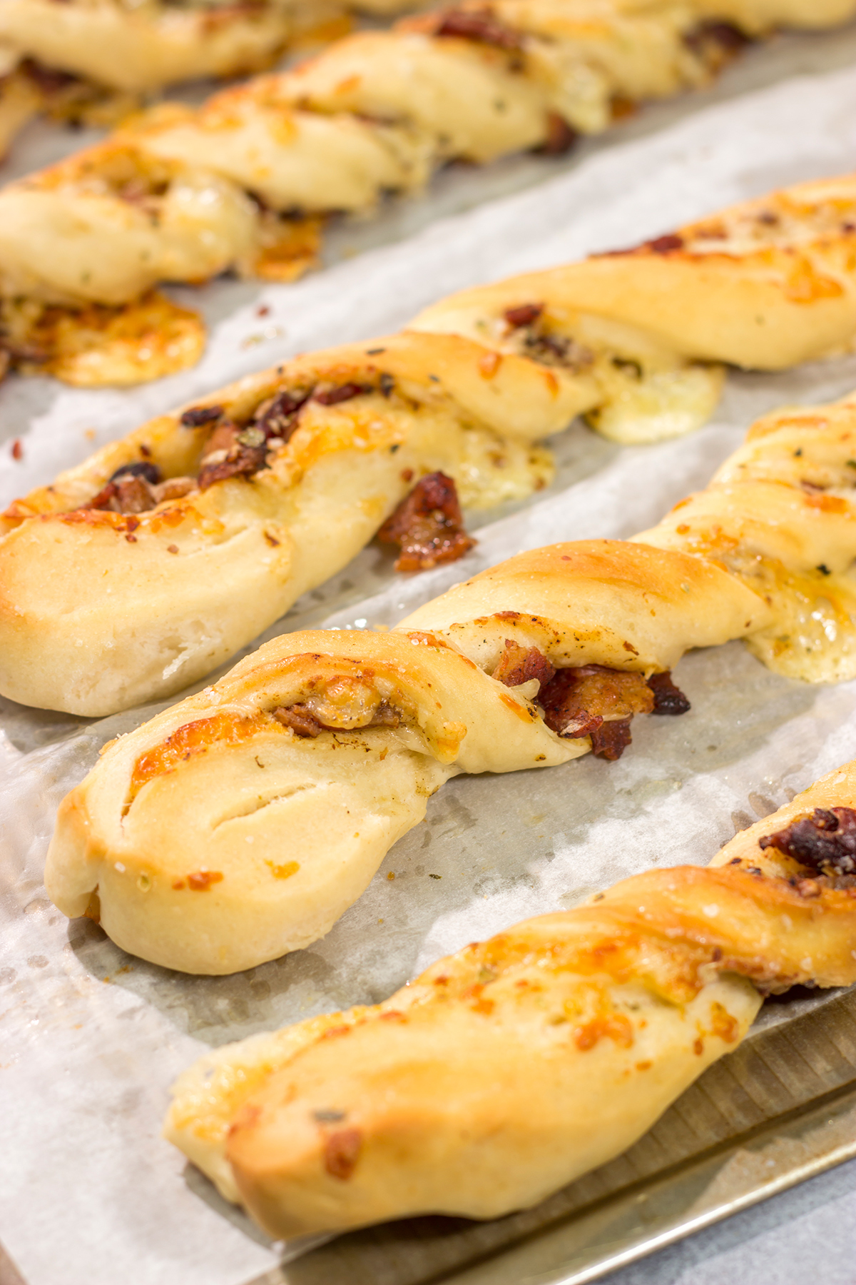 These Cheesy Bacon Breadsticks are proof that bacon and cheese make everything better! These breadsticks are great served as an appetizer or side dish. Enjoy!