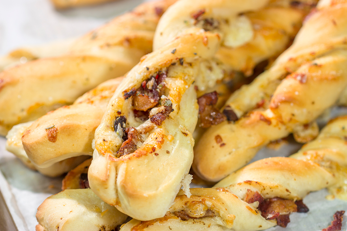 These Cheesy Bacon Breadsticks are proof that bacon and cheese make everything better! These breadsticks are great served as an appetizer or side dish. Enjoy!