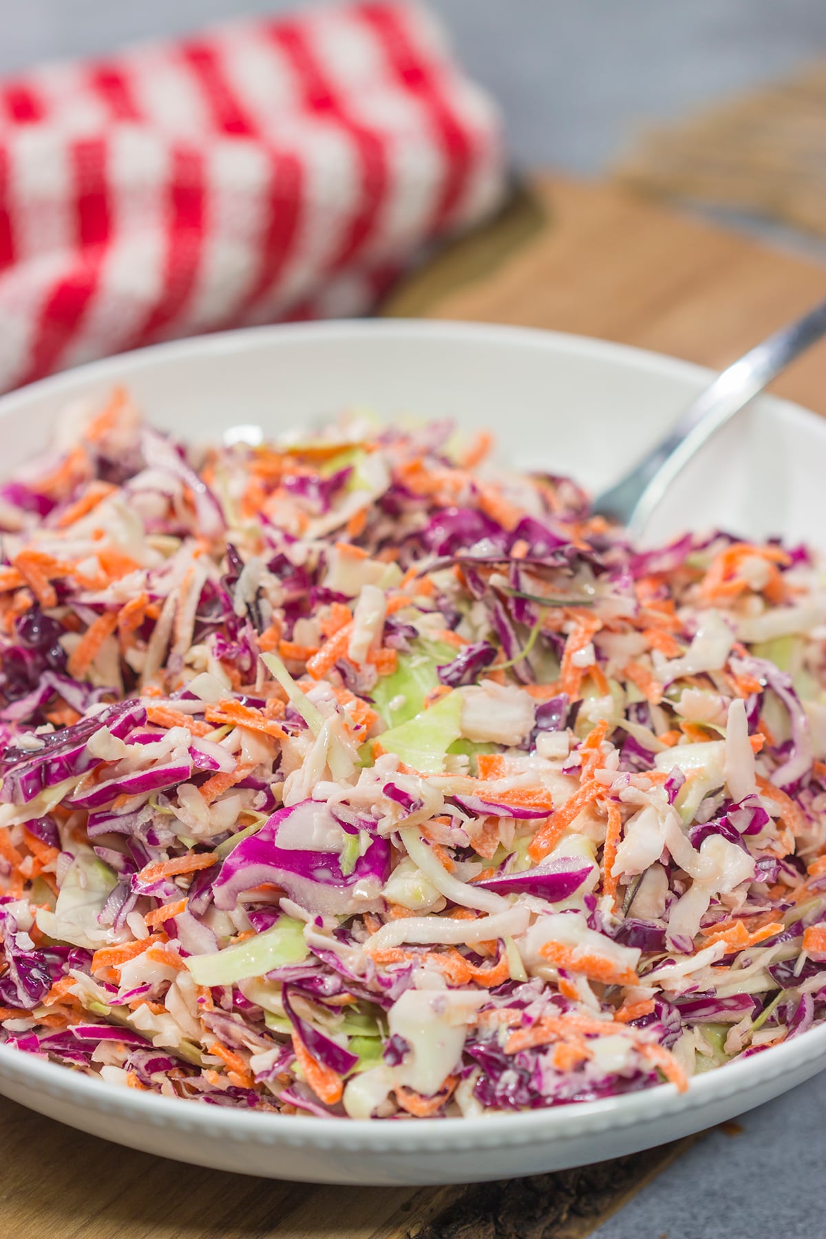 This Easy Coleslaw can be served as either a topping or a side dish. This creamy coleslaw recipe pairs well with barbecue, burgers and fried chicken.