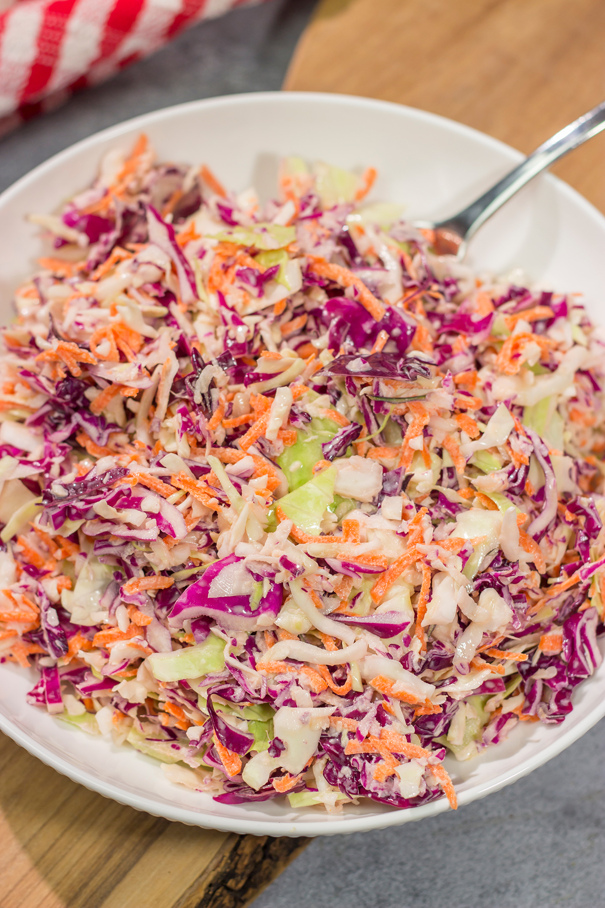 This Easy Coleslaw can be served as either a topping or a side dish. This creamy coleslaw recipe pairs well with barbecue, burgers and fried chicken.