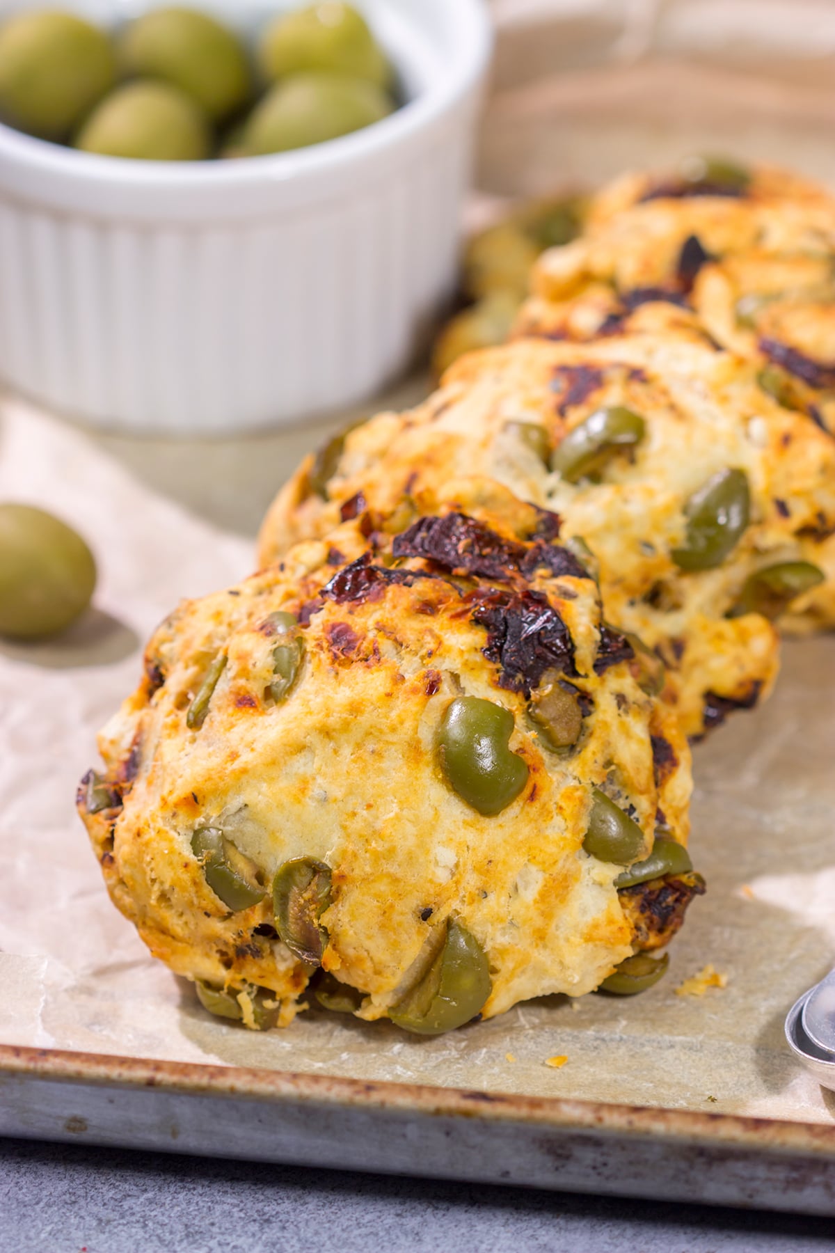 Put a savory spin on an old favorite! These Sundried Tomato and Olive Muffin Tops are packed with flavor. They're great next to a salad or a bowl of soup!