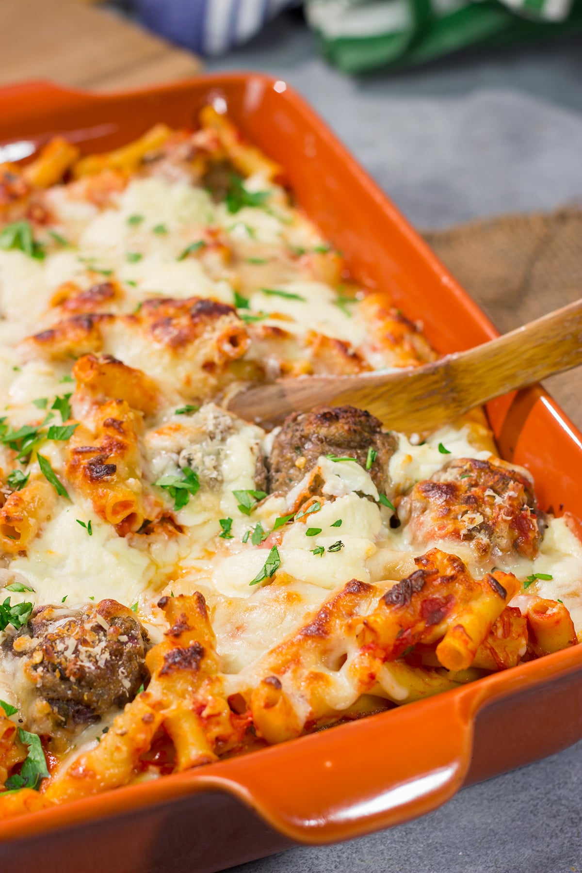 This Baked Ziti with Meatballs recipe is the ultimate comfort food. Pasta, gooey melted cheese and meatballs combine to create a delicious casserole!