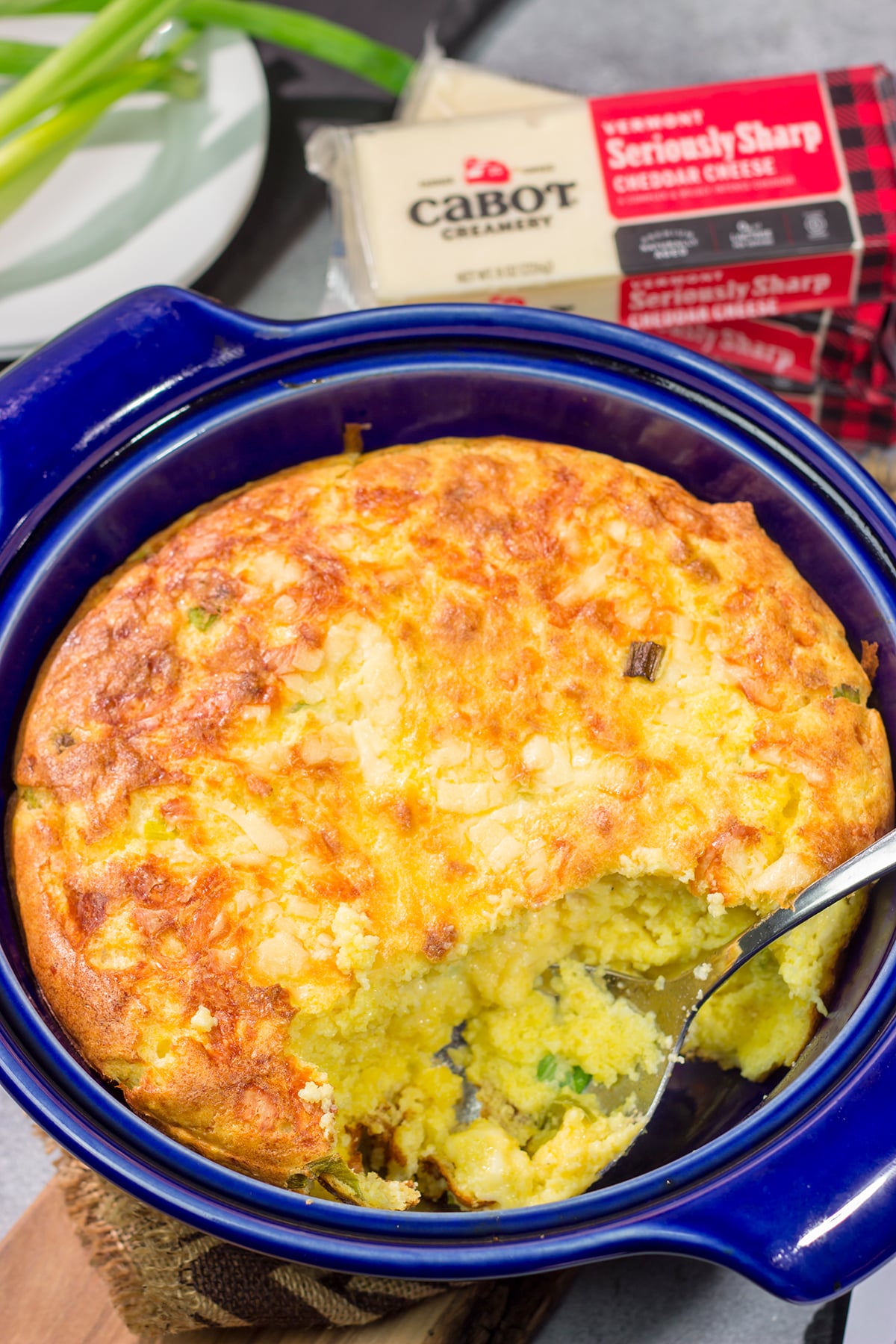 This Cheesy Spoon Bread is a cross between a souffle and cornbread. It's an easy dinner side dish that is packed with cheesy flavor!