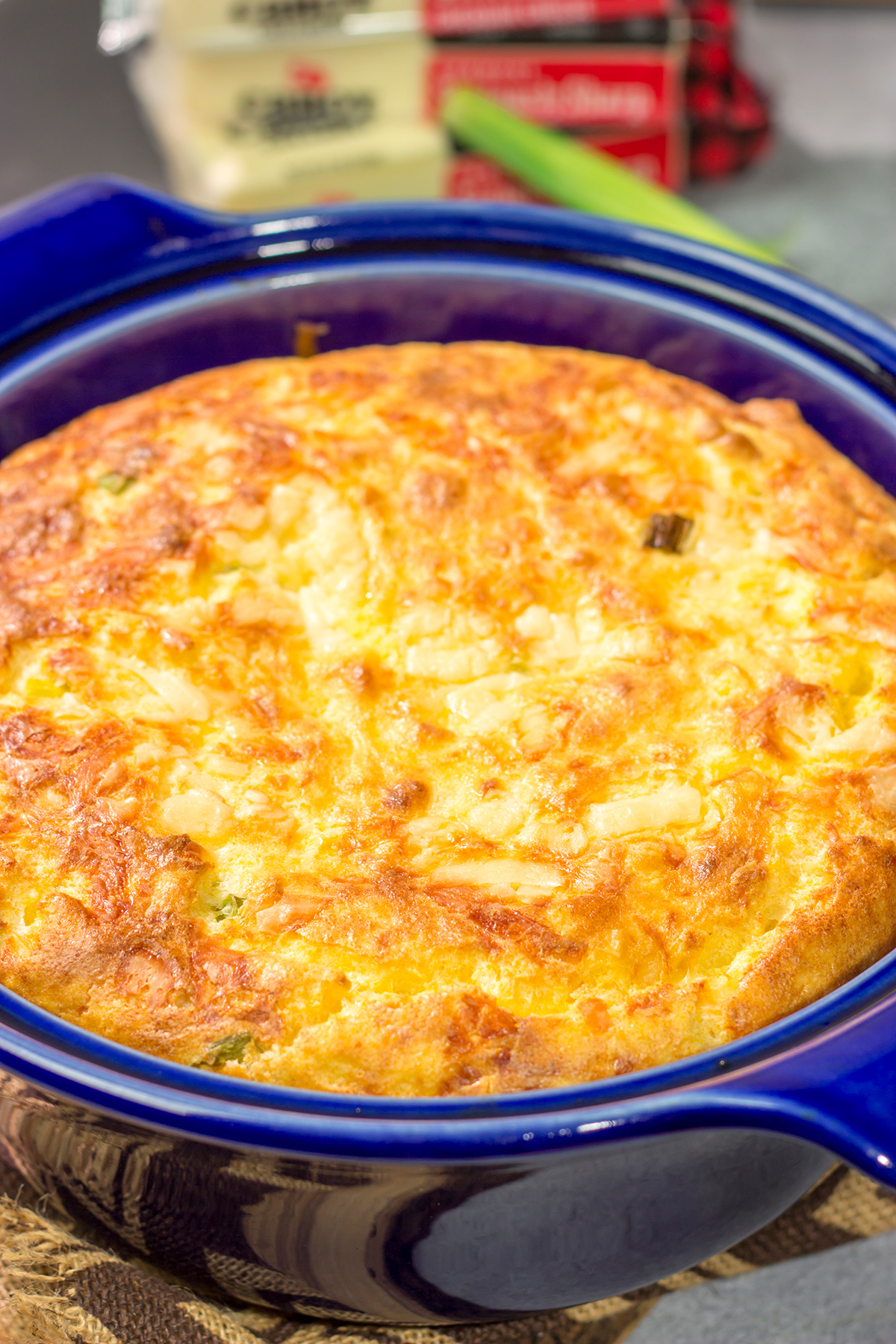 This Cheesy Spoon Bread is a cross between a souffle and cornbread. It's an easy dinner side dish that is packed with cheesy flavor!