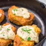 Fried Pork Chops are a classic Southern comfort food! These crispy, tender pork chops are served with an easy homemade gravy on top for maximum flavor.