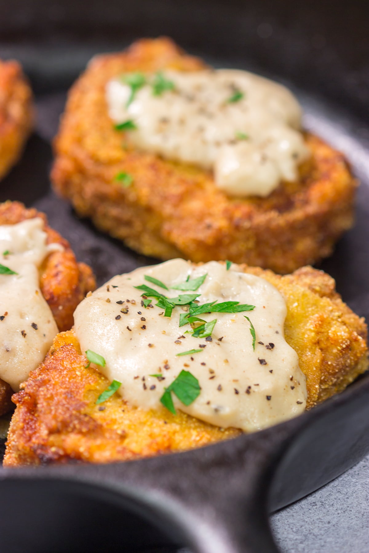 Fried Pork Chops are a classic Southern comfort food! These crispy, tender pork chops are served with an easy homemade gravy on top for maximum flavor.