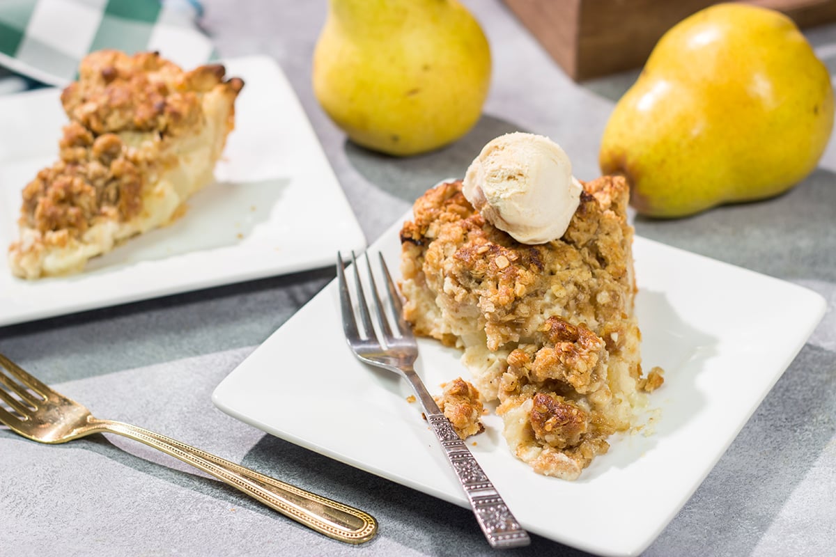 Sweet pears get tossed with a sour cream pie filling for a delicious and easy autumn dessert. This Pear Crumble Pie also gets topped with a brown sugar crumble - delicious!