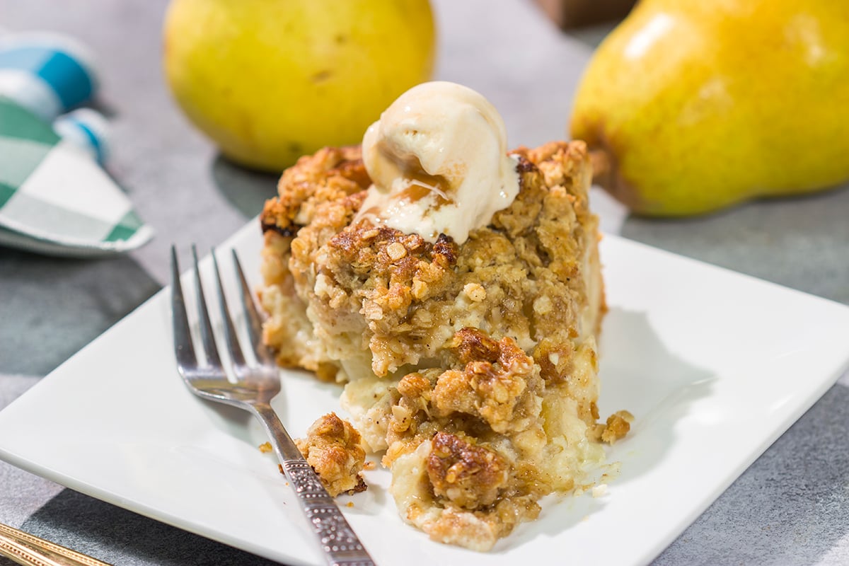 Sweet pears get tossed with a sour cream pie filling for a delicious and easy autumn dessert. This Pear Crumble Pie also gets topped with a brown sugar crumble - delicious!