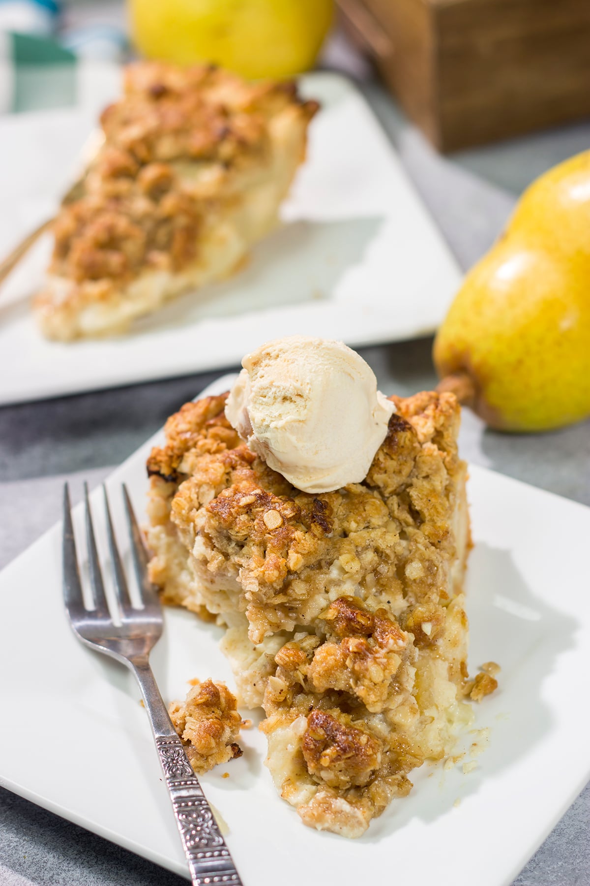 Sweet pears get tossed with a sour cream pie filling for a delicious and easy autumn dessert. This Pear Crumble Pie also gets topped with a brown sugar crumble - delicious!