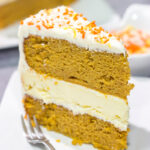This Pumpkin Spice Cheesecake Cake features a layer of cheesecake sandwiched in between 2 layers of pumpkin spice cake. It's a delicious autumn dessert!