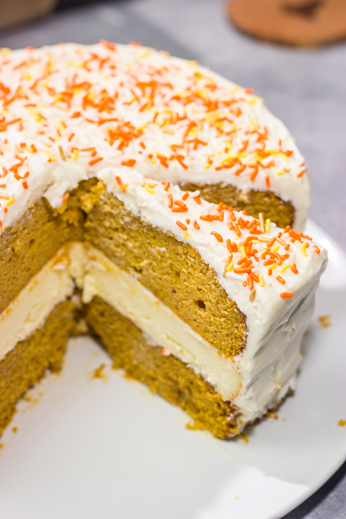 This Pumpkin Spice Cheesecake Cake features a layer of cheesecake sandwiched in between 2 layers of pumpkin spice cake. It's a delicious autumn dessert!