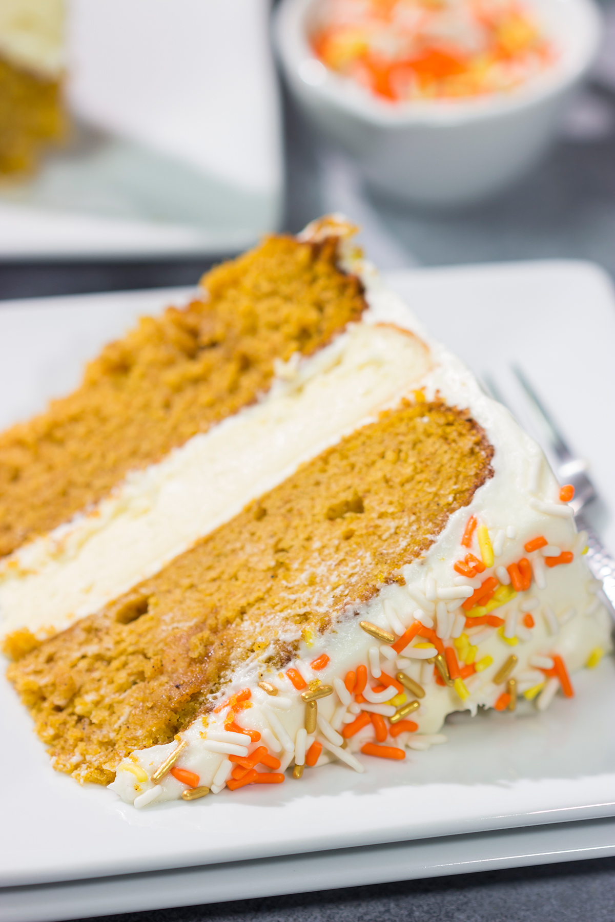 This Pumpkin Spice Cheesecake Cake features a layer of cheesecake sandwiched in between 2 layers of pumpkin spice cake. It's a delicious autumn dessert!