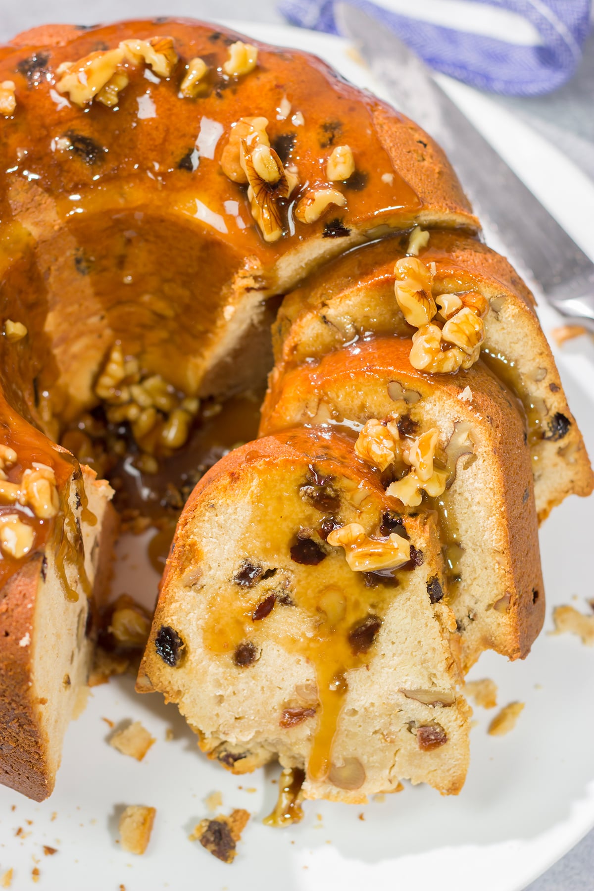 This Rum Raisin Pound Cake features a buttery cake studded with raisins and chopped walnuts. For extra flavor, a warm rum sauce gets poured over the cake before serving.