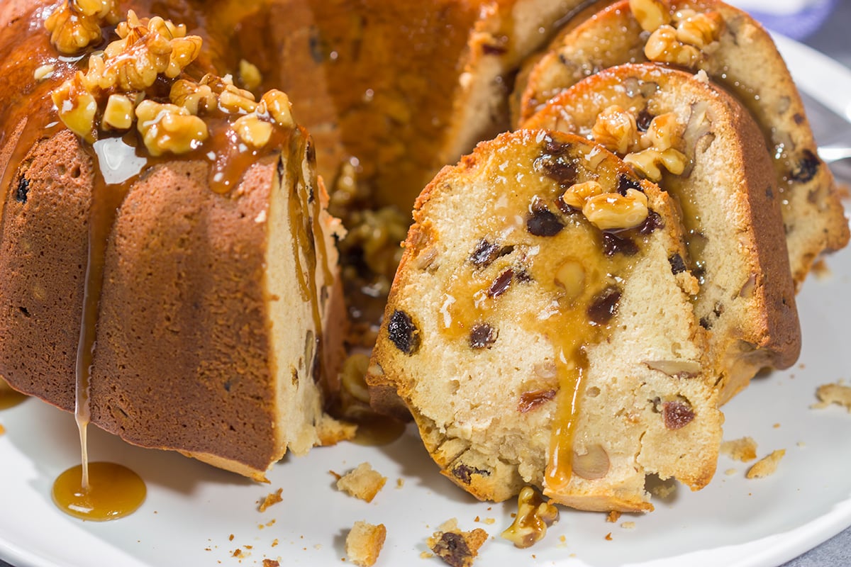 This Rum Raisin Pound Cake features a buttery cake studded with raisins and chopped walnuts. For extra flavor, a warm rum sauce gets poured over the cake before serving.