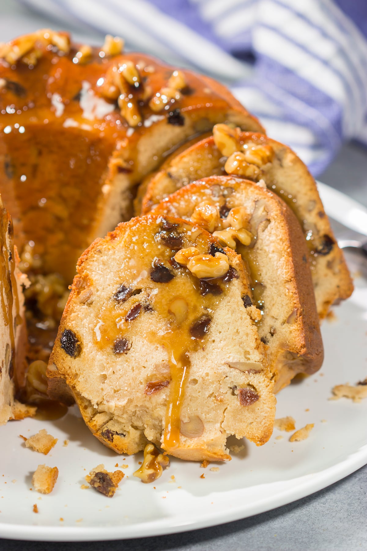 This Rum Raisin Pound Cake features a buttery cake studded with raisins and chopped walnuts. For extra flavor, a warm rum sauce gets poured over the cake before serving.