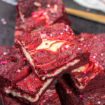 These Red Velvet Cheesecake Bars feature a chocolate brownie base topping with a layer of creamy cheesecake. They're perfect for Valentine's Day...or any day!
