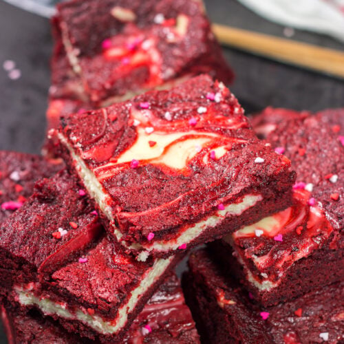 These Red Velvet Cheesecake Bars feature a chocolate brownie base topping with a layer of creamy cheesecake. They're perfect for Valentine's Day...or any day!