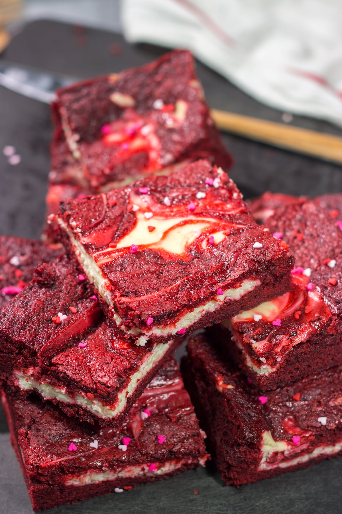 These Red Velvet Cheesecake Bars feature a chocolate brownie base topping with a layer of creamy cheesecake. They're perfect for Valentine's Day...or any day!