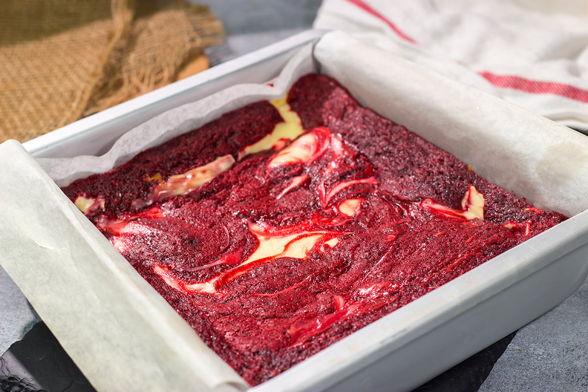 These Red Velvet Cheesecake Bars feature a chocolate brownie base topping with a layer of creamy cheesecake. They're perfect for Valentine's Day...or any day!
