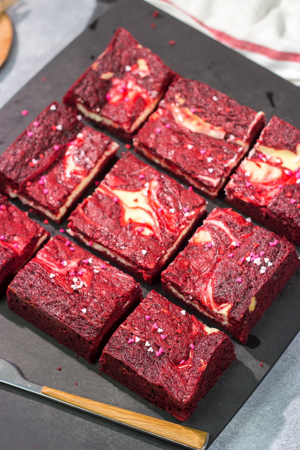 These Red Velvet Cheesecake Bars feature a chocolate brownie base topping with a layer of creamy cheesecake. They're perfect for Valentine's Day...or any day!