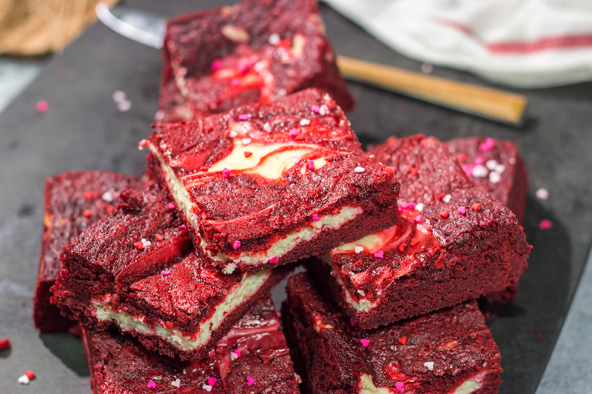 These Red Velvet Cheesecake Bars feature a chocolate brownie base topping with a layer of creamy cheesecake. They're perfect for Valentine's Day...or any day!