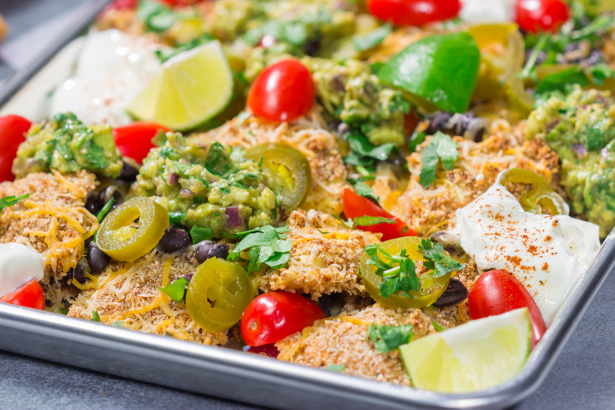 Skip the chips! These Toasted Ravioli Nachos feature all of your favorite nacho toppings on top of toasted ravioli. Go ahead and make an extra batch...you'll need it!
