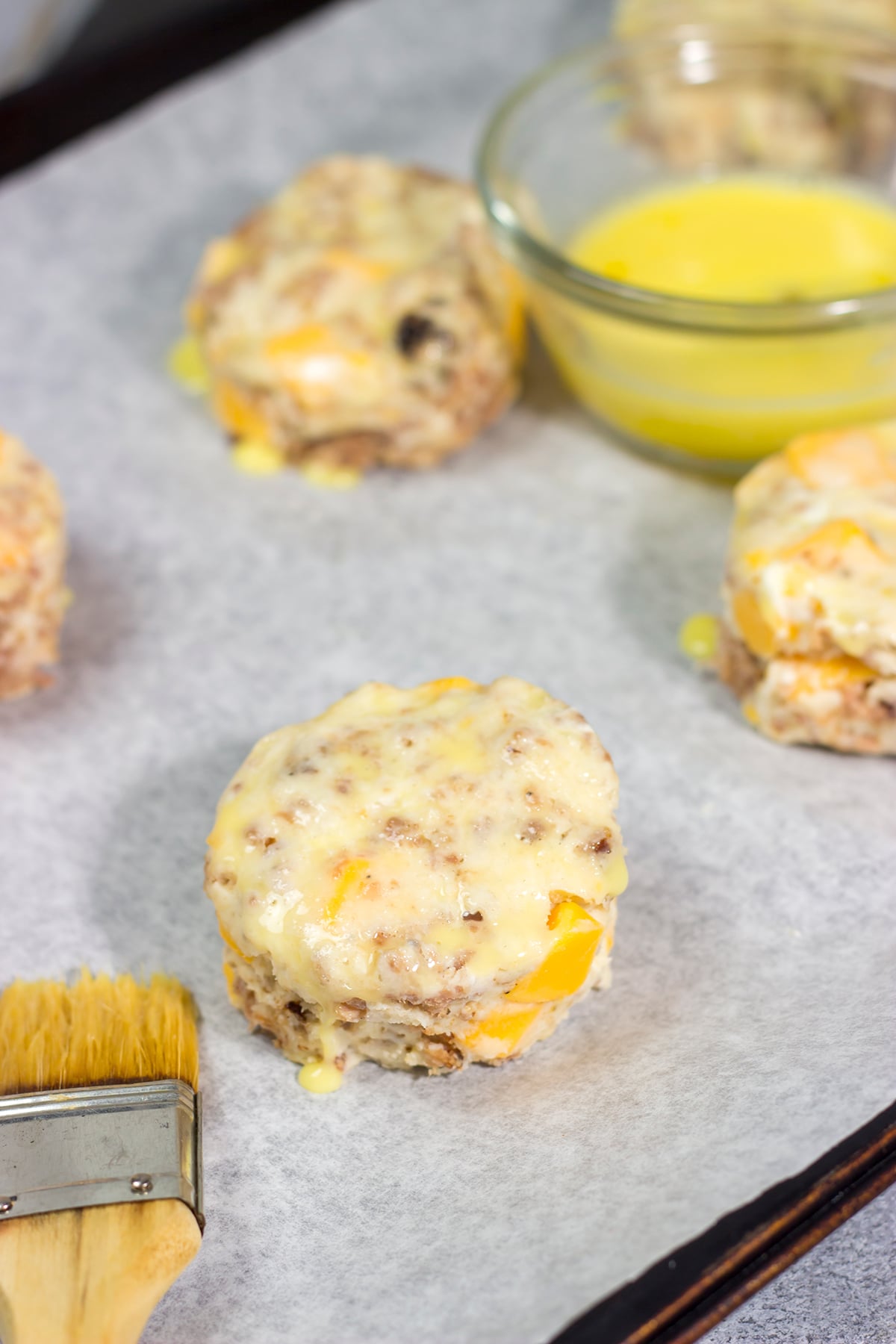 Instead of putting sausage and cheese on a biscuit, put sausage and cheese IN a biscuit! These Cheesy Sausage Biscuits are the perfect savory breakfast for a cold morning.
