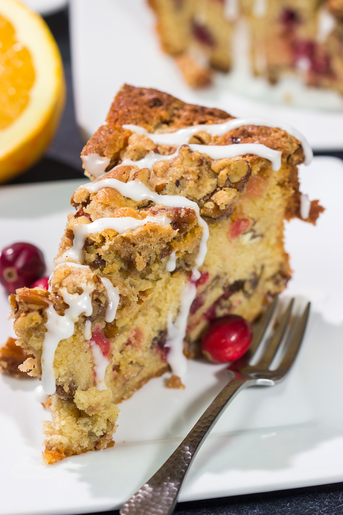 This Cranberry Pecan Coffee Cake is packed with pecans and fresh cranberries, and it's topped with a brown sugar streusel. This treat is perfect for holiday brunch!