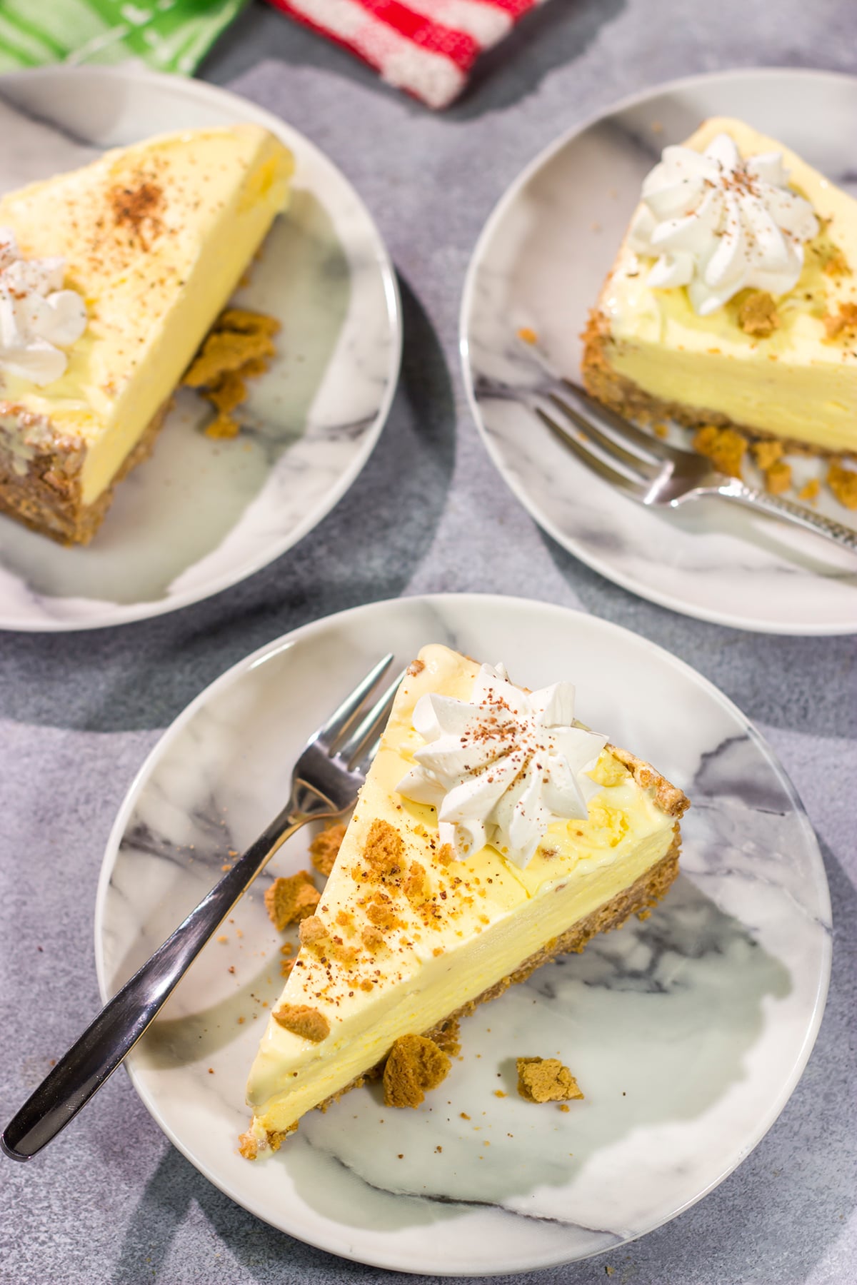 Who says ice cream is only for warm weather? This Eggnog Ice Cream Pie features creamy ice cream in a gingersnap cookie crust - it's a delicious treat for the holiday season!