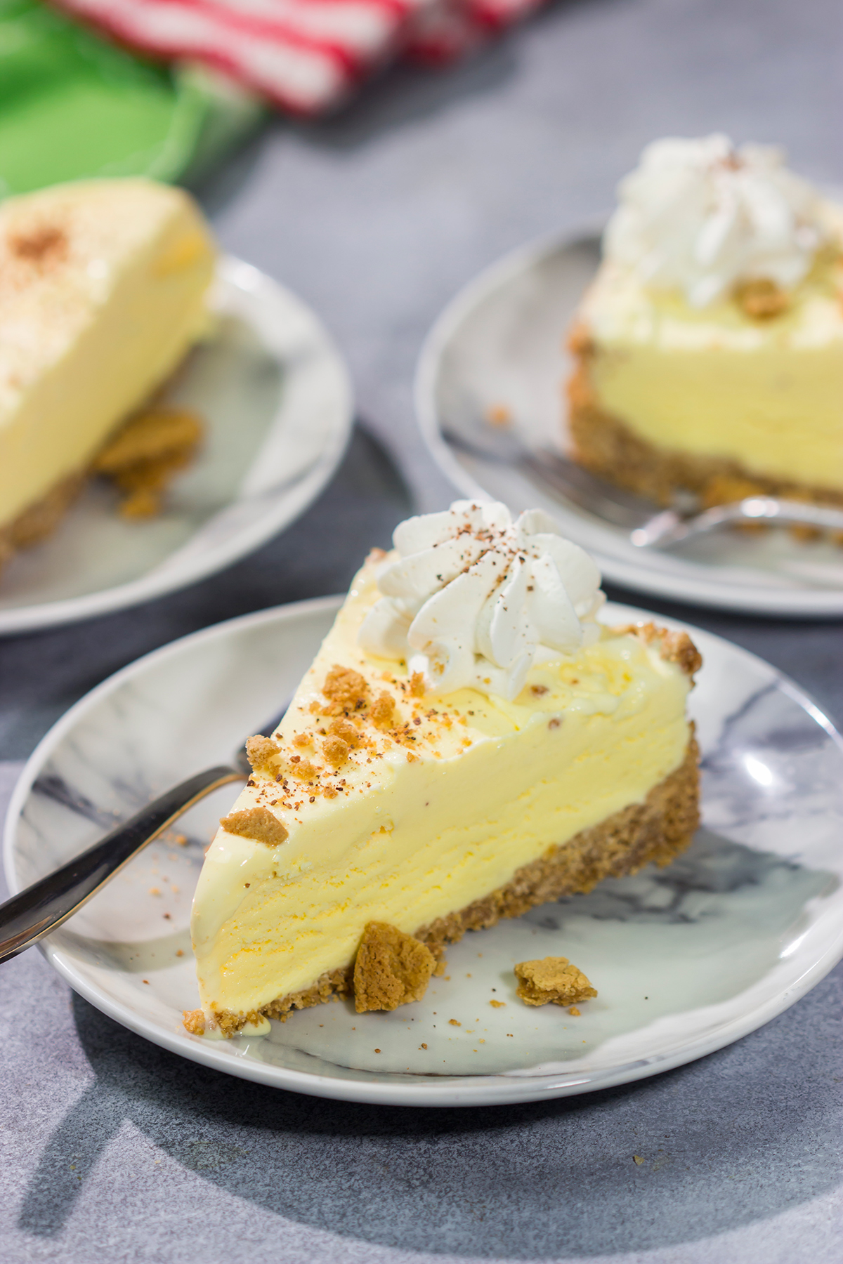 Who says ice cream is only for warm weather? This Eggnog Ice Cream Pie features creamy ice cream in a gingersnap cookie crust - it's a delicious treat for the holiday season!