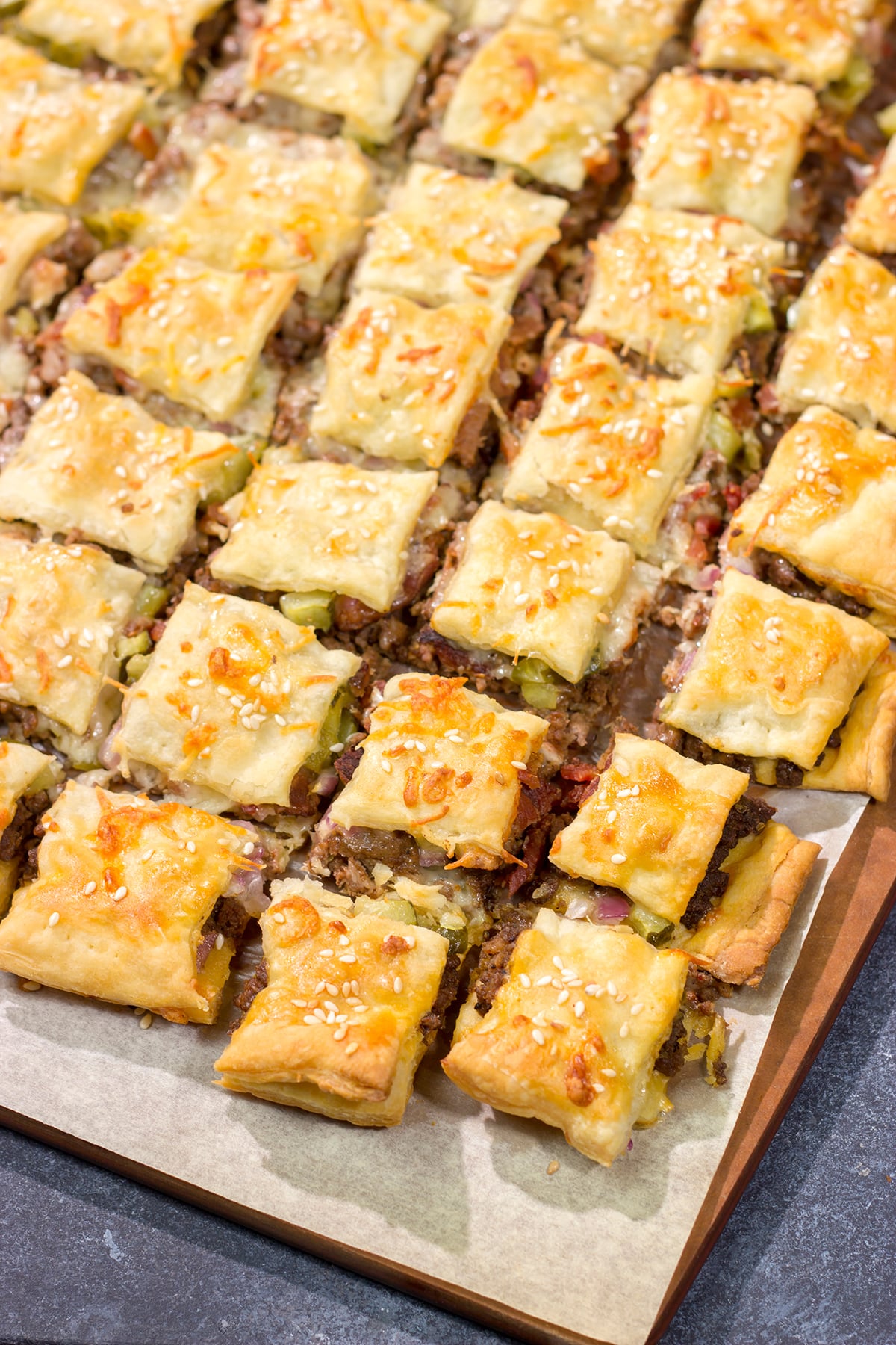 Sandwiched between two layers of puff pastry, these tasty Bacon Cheeseburger Bites are the perfect party appetizer!
