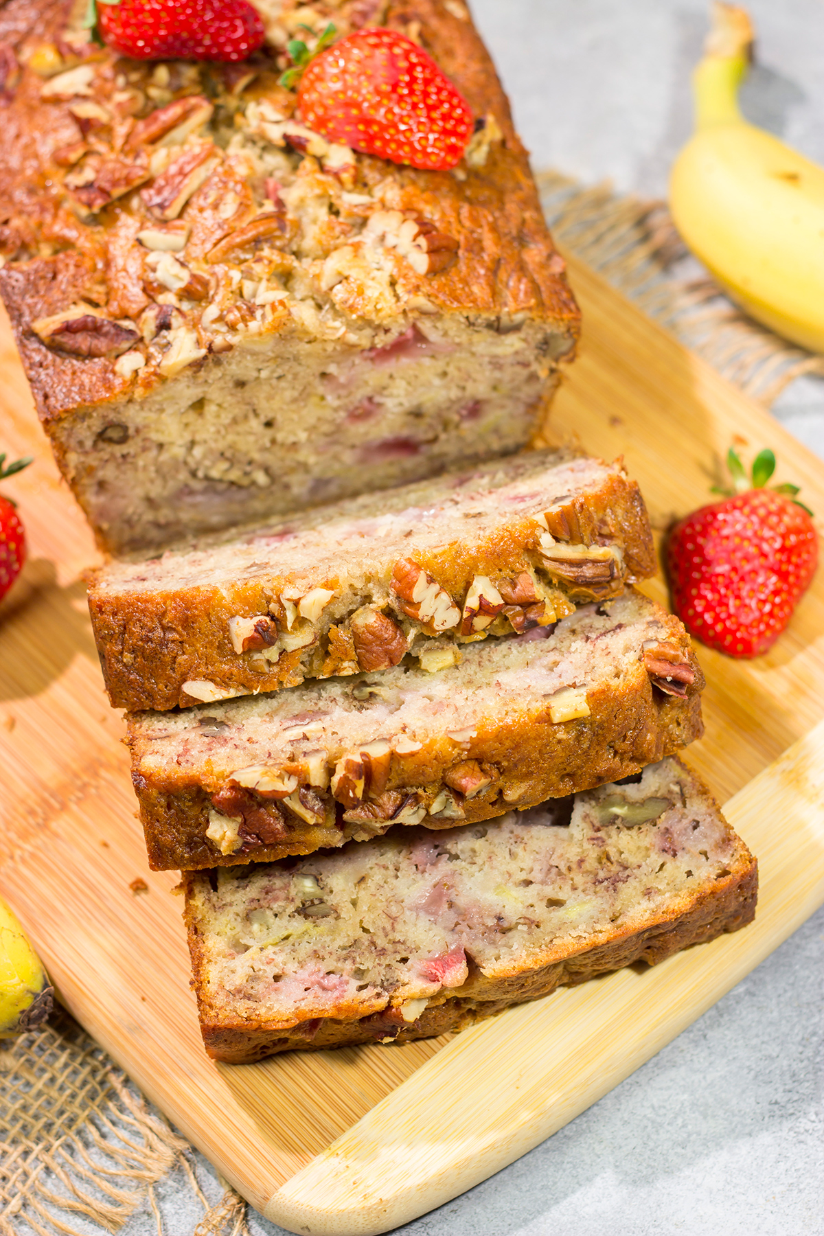 This Strawberry Banana Bread is packed with ripe banana + fresh strawberry flavor. A slice of this bread with a mug of hot coffee is a pretty fantastic way to start the day!